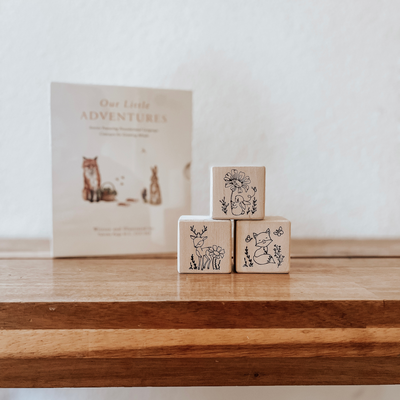 Wooden non-toxic baby blocks engraved with woodland animals used as nursery room decor