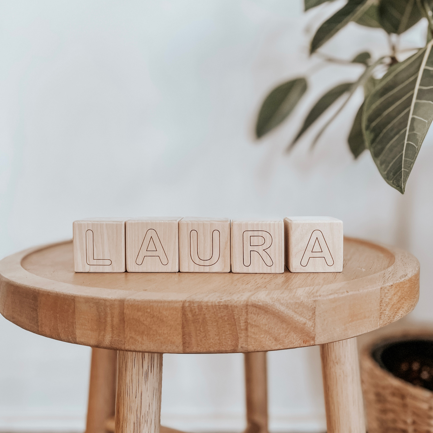 Personalized baby blocks with a name engraved on wooden blocks and used as room decor