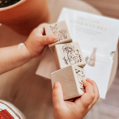 Wooden non-toxic baby blocks engraved with woodland animals used as nursery room decor