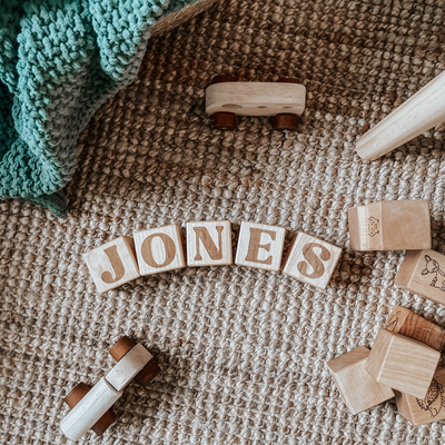 Handmade wooden nursery blocks in a neutral nursery