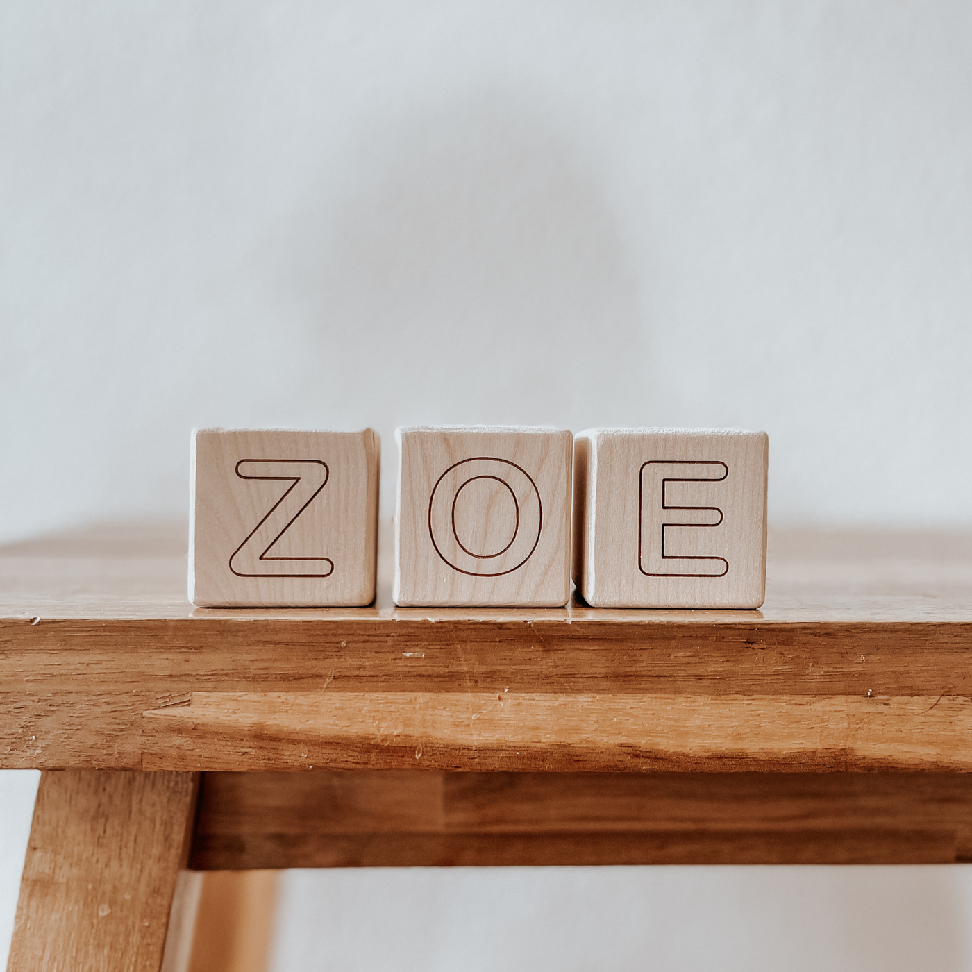 Personalized baby blocks with a name engraved on wooden blocks and used as room decor