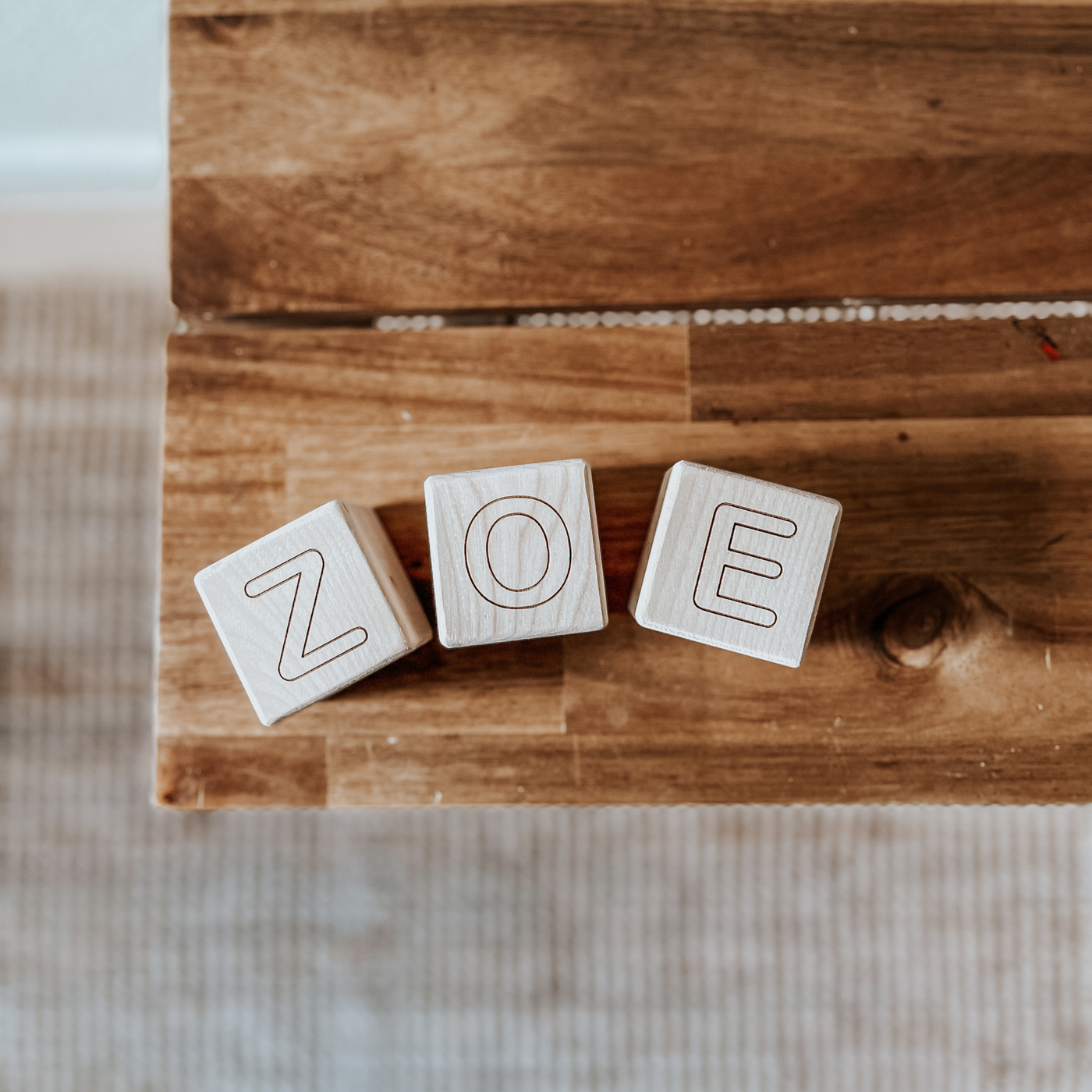 Personalized baby blocks with a name engraved on wooden blocks and used as room decor