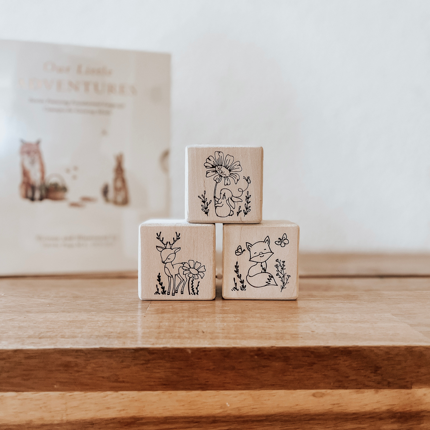 Wooden non-toxic baby blocks engraved with woodland animals used as nursery room decor