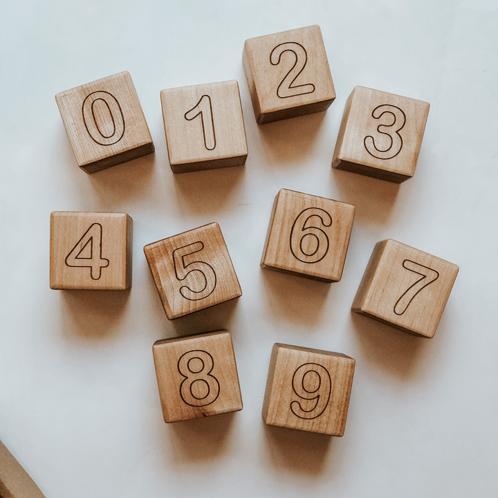 Wooden blocks engraved with numbers 0 through 9